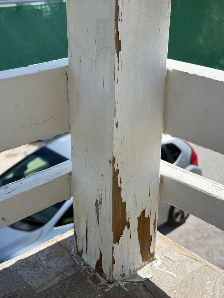 Outdoor Banister with flaking paint before renovations